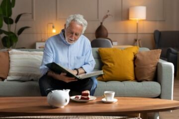 Caregivers assisting elderly man with photos. Tips on how to start a senior care business and home health services.